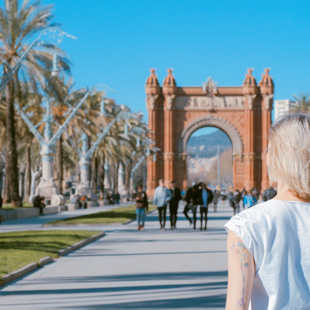 woman standing on the road in front of Arco de Triunfo, Barcelona